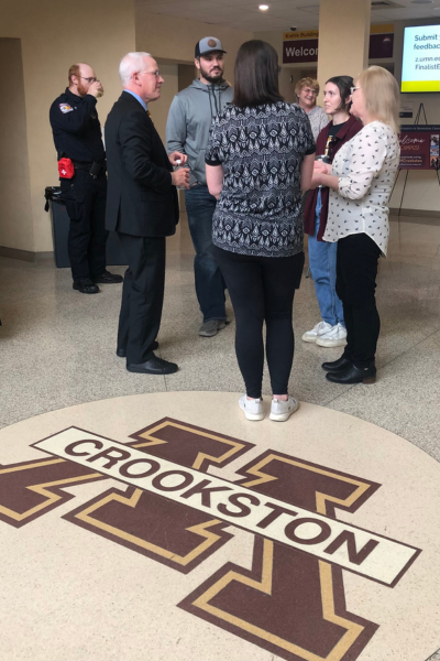 Dr. James Holloway speaking with people on the Crookston campus